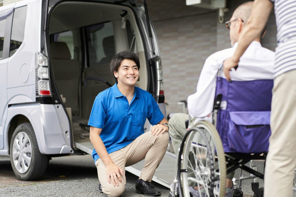 Caregiver picks up elderly in a long-term care taxi