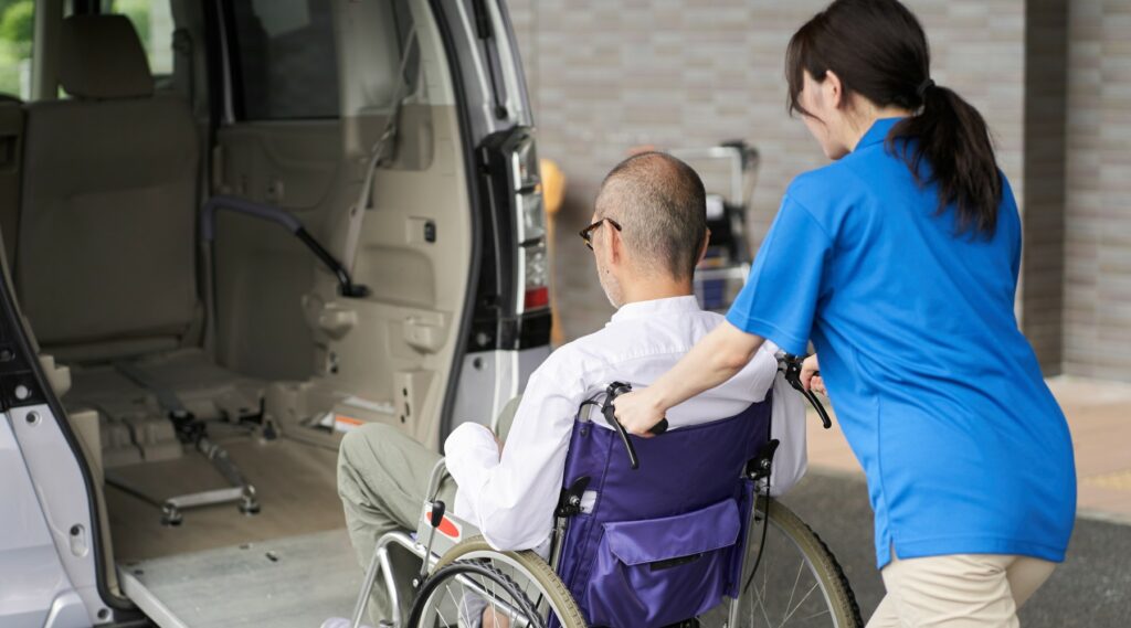 A caregiver who puts an elderly person in a long-term care taxi