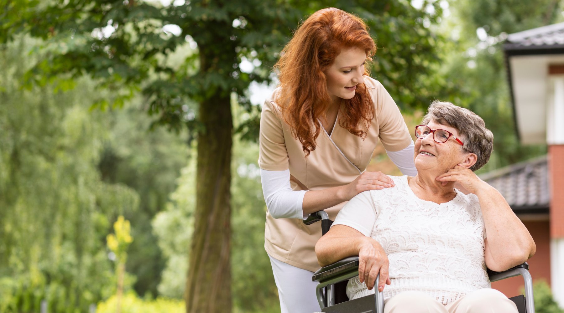 A female volunteer helping an elderly woman