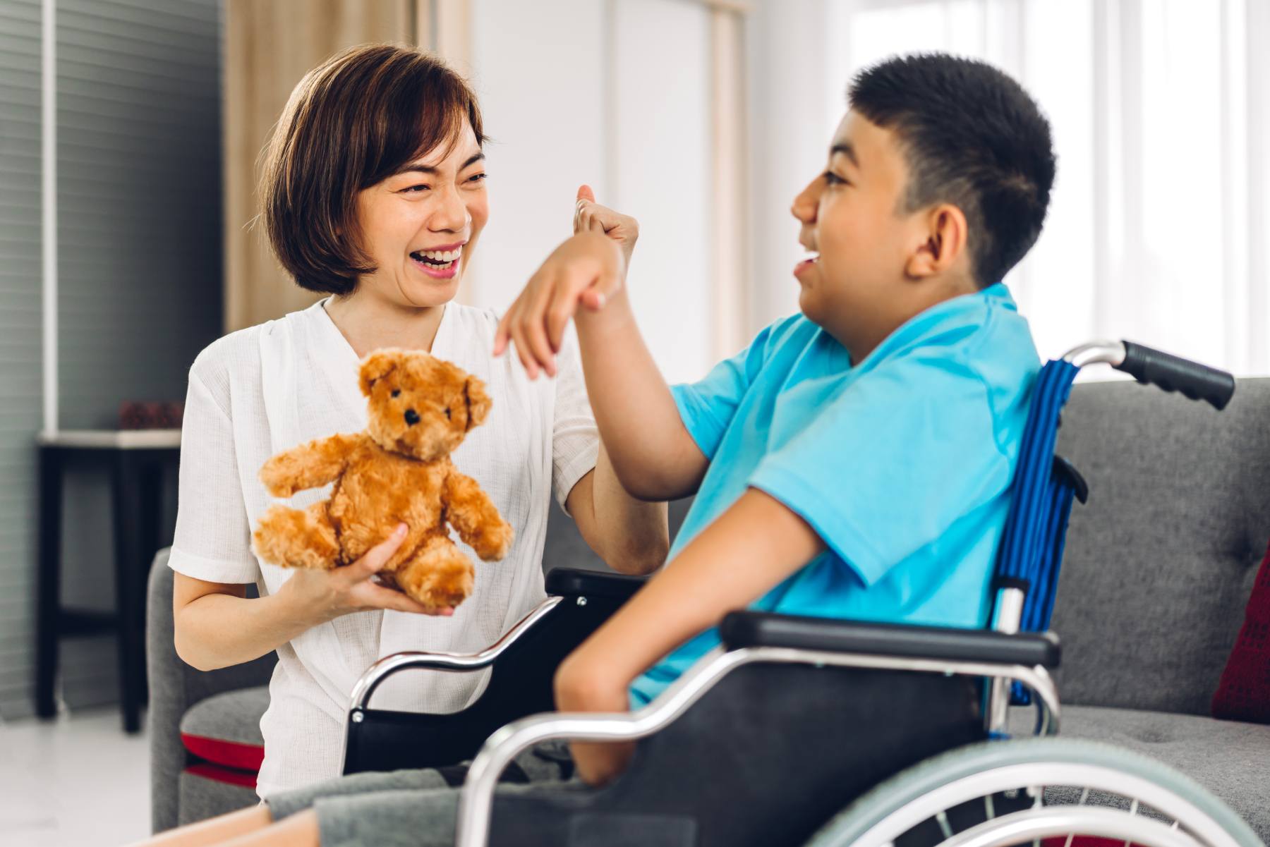 Portrait of happy love family asian mother play and helping look at disabled son child